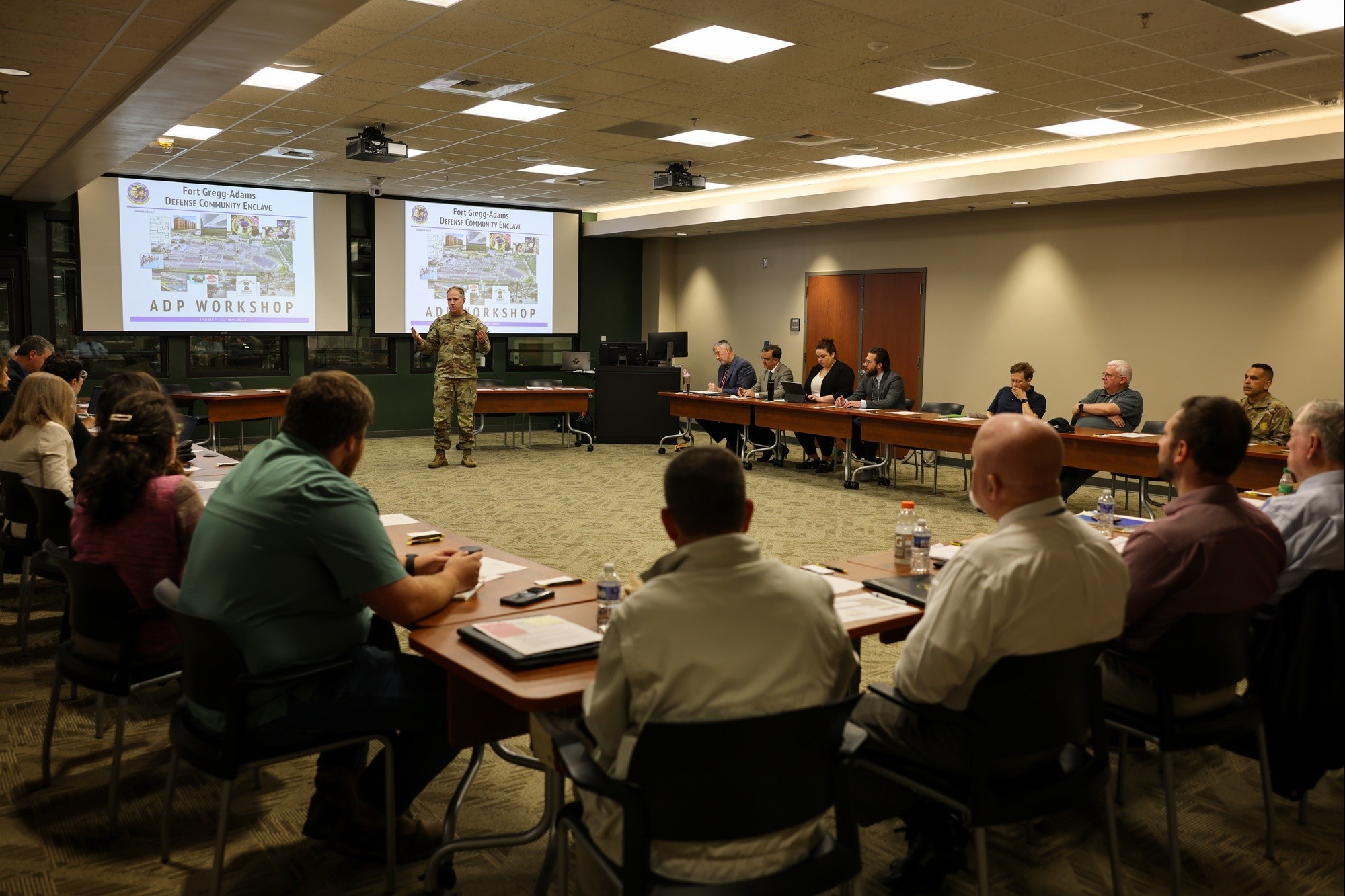 image of soldier speaking to a room full of individuals