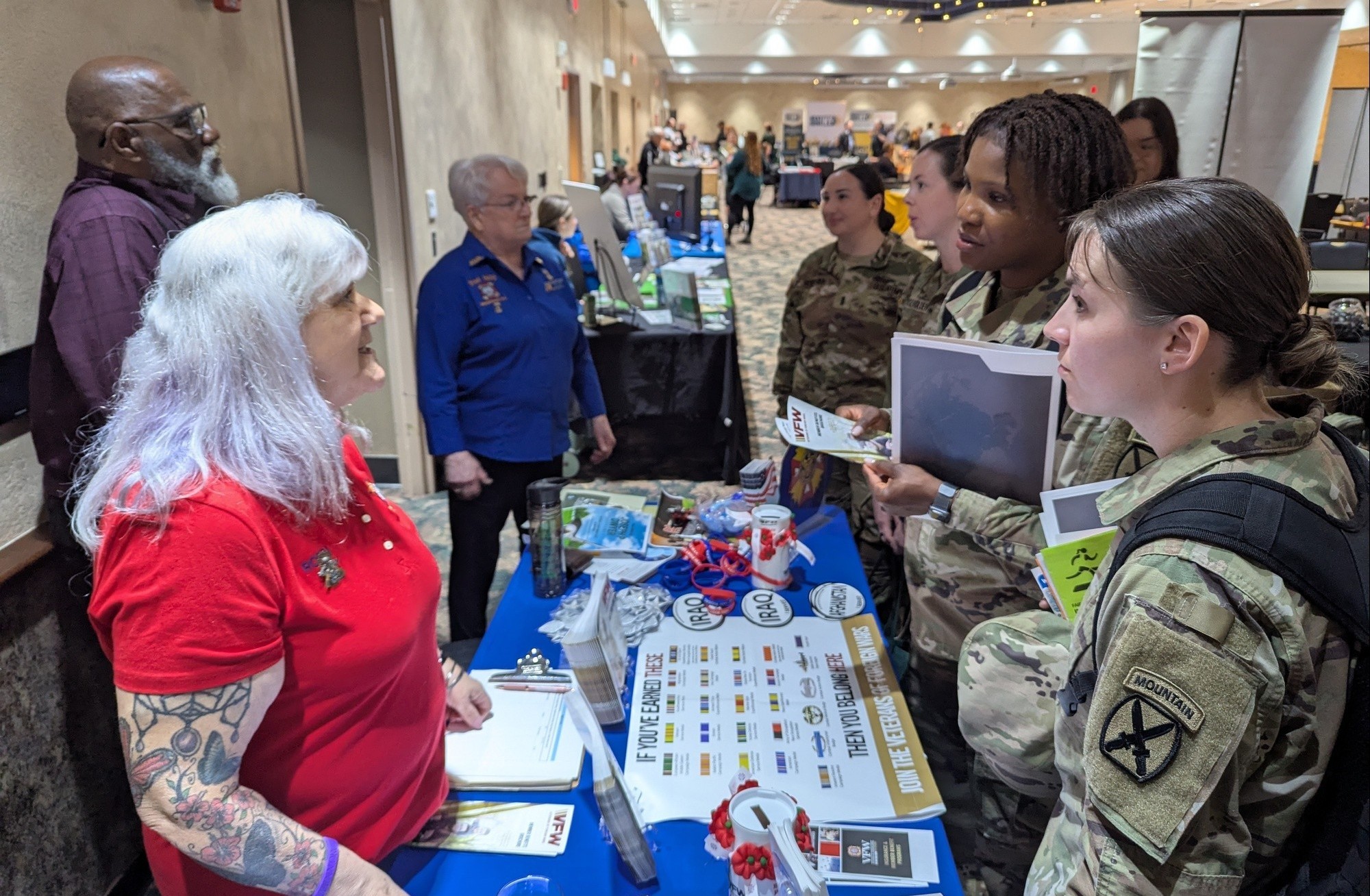Image of soldier talking with workers